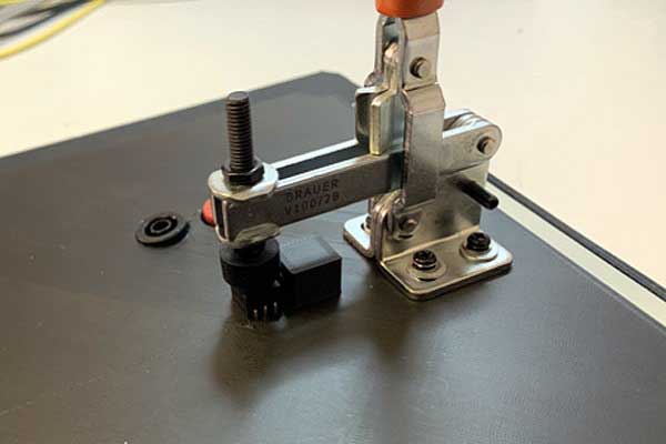 Detail of clamp engaged to hold UUT in place.